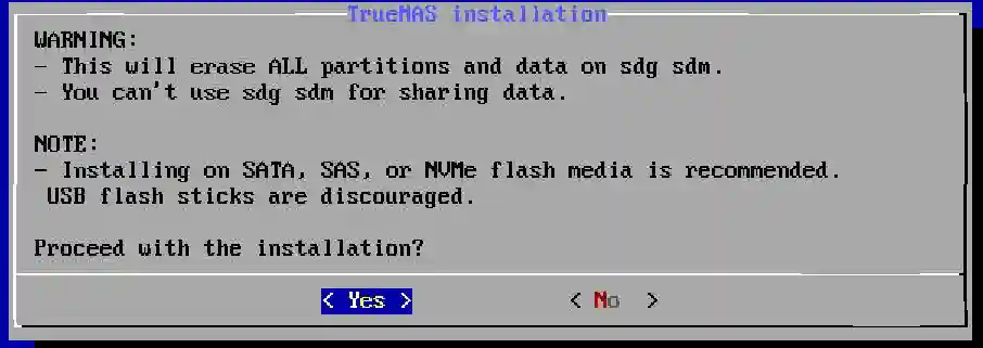 Warning and note on the TrueNAS installation screen indicating data erasure on selected drives and media recommendations, with options to proceed or cancel.